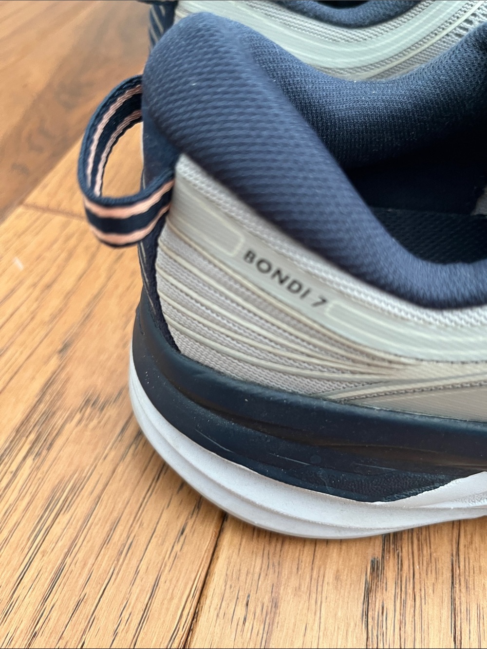 Hoka Bondi 7 woman’s Running Shoes in Light Gray with Navy and Orange Accents - Picture 2 of 4
